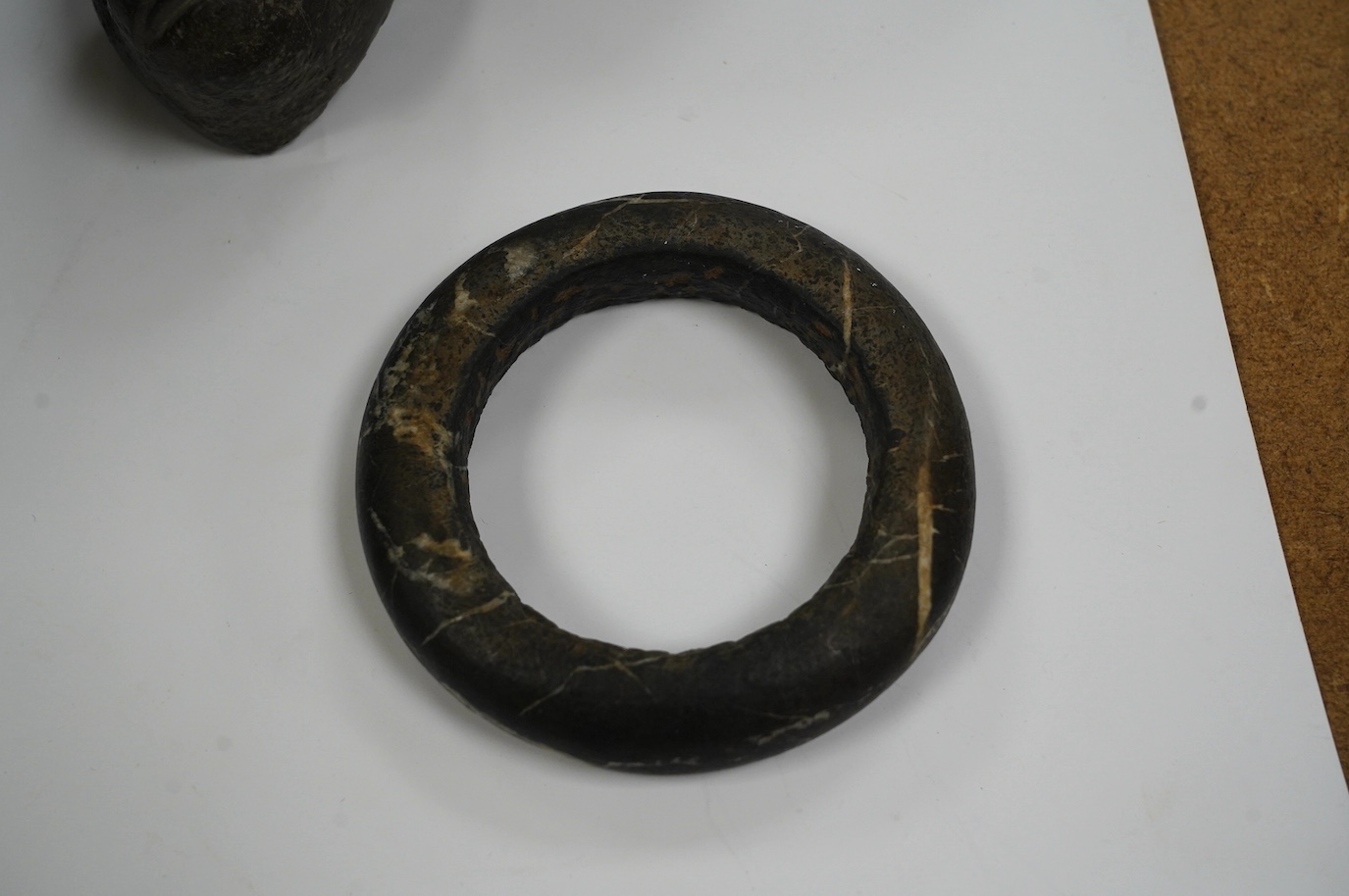 An African Dogon tribe carved stone bracelet, 10cm diameter, an Ethiopian black glazed terracotta bowl, 11cm diameter, Gurage people, and a carved black stone head of a monkey, 5.5cm, possibly North American. Condition -